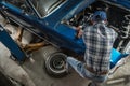 Car Mechanic in His 40s Performing Classic Car Repair Royalty Free Stock Photo