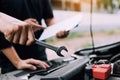 Car mechanic is holding a wrench ready to check the engine and maintenance Royalty Free Stock Photo