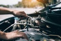 Car mechanic is holding a wrench ready to check the engine and maintenance Royalty Free Stock Photo