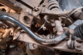 Car mechanic inspecting car wheel and repair suspension detail. Lifted automobile at repair service station. replacement Royalty Free Stock Photo