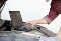 Car mechanic with laptop