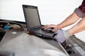 Car mechanic with laptop