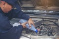 Car Mechanic man hands pouring Deionized purified Distilled water for car battery mechanical service. Close up hands man hold