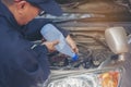 Car Mechanic man hands pouring Deionized purified Distilled water for car battery mechanical service. Close up hands man hold