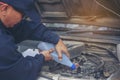 Car Mechanic man hands pouring Deionized purified Distilled water for car battery mechanical service. Close up hands man hold