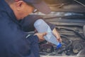 Car Mechanic man hands pouring Deionized purified Distilled water for car battery mechanical service. Close up hands man hold