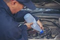 Car Mechanic man hands pouring Deionized purified Distilled water for car battery mechanical service. Close up hands man hold