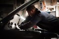 Car mechanic repairer service technician checks and repairs auto engine