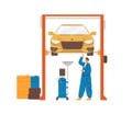 Car mechanic repairing auto lifted on elevator in workshop. Automobile diagnostics and maintenance by professional