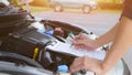 Car mechanic repairman checking a car engine with inspecting writing on clipboard the checklist for repair car, Car Repairs, Royalty Free Stock Photo