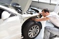 Car mechanic repairs car bodywork of a vehicle after a traffic a