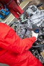 A car mechanic repairs an engine in a car service. Royalty Free Stock Photo