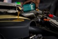 Car mechanic replacing and pouring fresh oil into engine at maintenance repair service station, Mechanic pouring oil into car at t Royalty Free Stock Photo