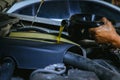 Car mechanic replacing and pouring fresh oil into engine at maintenance repair service station, Mechanic pouring oil into car at t Royalty Free Stock Photo