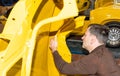 Car mechanic screws car parts together again after restoration - Serie Repair Workshop Royalty Free Stock Photo