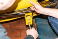 Car mechanic screws car parts together again after restoration - Serie Repair Workshop Royalty Free Stock Photo