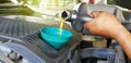 Car mechanic or serviceman fills a fresh lubricant engine oil at car garage for repair or maintenance a car Royalty Free Stock Photo