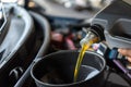 Car mechanic fills a fresh lubricant engine oil Royalty Free Stock Photo