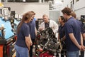 Car mechanic showing engines to apprentices Royalty Free Stock Photo