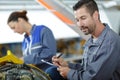 car mechanic team with diagnosis tool in workshop Royalty Free Stock Photo