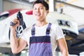 Car mechanic with tool in Asian Chinese auto workshop Royalty Free Stock Photo