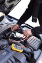 Car mechanic using an electronic device Royalty Free Stock Photo