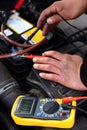 Car mechanic using an electronic device Royalty Free Stock Photo