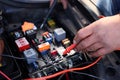 Car mechanic using an electronic device Royalty Free Stock Photo