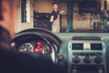 Car mechanic welcomes new client to his auto repair service. Royalty Free Stock Photo