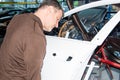 Car mechanics align the bonnet correctly when assembling - Serie Repair Workshop