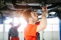 Car mechanics working at automotive service center Royalty Free Stock Photo