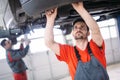 Car mechanics working at automotive service center Royalty Free Stock Photo