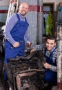 Car mechanics working at carshop