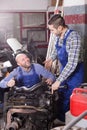 Car mechanics working at carshop