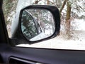 Car mirror. Forest in rear view mirror closeup. Reflected in a rearview. In the background forest. Winter Royalty Free Stock Photo