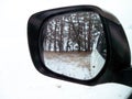 Car mirror. Forest in rear view mirror closeup. Reflected in a rearview. In the background forest. Winter Royalty Free Stock Photo