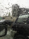 car mirror through glass with drops in the dark Royalty Free Stock Photo