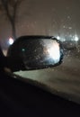 car mirror through glass with drops in the dark Royalty Free Stock Photo