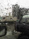 car mirror through glass with drops in the dark Royalty Free Stock Photo