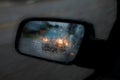 Car Mirror in Rain and Traffic Royalty Free Stock Photo
