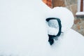 Car mirror in snow. Frozen, snow covered passenger car mirror