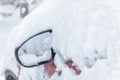 The car mirror sticks out from the snowdrift in Moscow