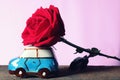 A car model carrying big beautiful red rose. Happy Valentine& x27;s day concept