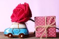A car model carrying jumbo beautiful red rose and gift box, delivering love. Happy Valentine& x27;s day concept
