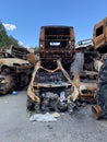 Car morgue. Civilian vehicles after the fire. Rusty pile of metal. Auto in Irpen.