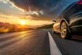 car on mountain road traveling around the world highways and sunset, tires on the asphalt road Royalty Free Stock Photo