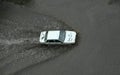 A car moving through the flooded road after intensive shower Royalty Free Stock Photo