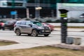 Car moving at high speed on the city street. A black car drives fast through the city with motion blur effect. excess speed limit Royalty Free Stock Photo