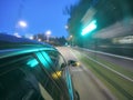 The car is moving at high speed on the night road in the city. Royalty Free Stock Photo