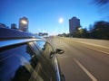 The car is moving at high speed on the night road in the city. Royalty Free Stock Photo